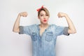 I am Strong. Portrait of independent proud satisfied beautiful young woman in blue denim shirt, makeup, red headband standing,