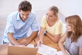 I suggest we build it here...High-angle view of a team of businesspeople discussing important documents. Royalty Free Stock Photo