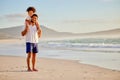 I sustain myself with the love of family. a father carrying his daughter at the beach.