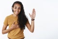 I swear geez. Portrait of cute and friendly happy young nice african-american girl with curly hair raising palm and Royalty Free Stock Photo