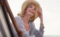 I swear I havent loved the beach more. an attractive senior woman relaxing on a lounger on a summers day at the beach.