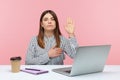 I swear! Honest dedicated woman office worker raising hand to give promise sitting at workplace, taking oath with trustworthy Royalty Free Stock Photo
