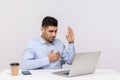 I swear! Honest man employee sitting office workplace, making sincere promise while talking video call on laptop Royalty Free Stock Photo