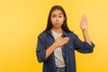 I swear! Portrait of honest girl in denim shirt taking sacred oath, making solemn vow in ceremonial tradition