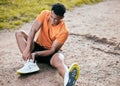 I think I need to get new running shoes. Full length shot of a young man sitting alone outside and suffering from an