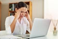 I think I need to lie down. a young businesswoman experiencing a headache while working from home.