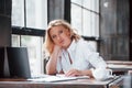 I think I will do some work on this weekend. Businesswoman with curly blonde hair indoors in cafe at daytime