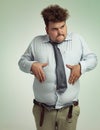 I think its time to lose some weight. an overweight man holding his rotund belly.