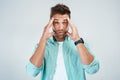 I think I should go lie down. Studio shot of a young man with an uncomfortable facial expression due to a headache while