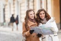 I think we should go there. Two beautiful young women holding a Royalty Free Stock Photo