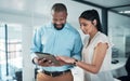 I think theres room for some improvement here. two businesspeople standing together in the office and using a tablet. Royalty Free Stock Photo