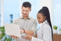 I think you have a strong idea here. Shot of two young businesspeople standing together in the office and using a laptop Royalty Free Stock Photo