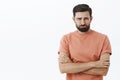 I thought you loved me. Crying bearded 30s guy frowning grimacing in sorrow holding hands crossed over body in defensive Royalty Free Stock Photo