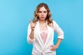 I told you! Portrait of bossy woman frowning face and pointing finger up in warning gesture. studio shot, blue background