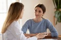 Millennial female visitor of clinic discussing problem with trusted physician