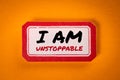 I AM UNSTOPPABLE. Sticky note with text on an orange background