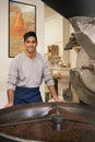 I only use the finest beans. Cropped portrait of a young man grinding and roasting coffee beans.