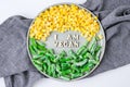 I AM VEGAN text in plate. Veganism, vegetarian healthy lifestyle. Healthy eating vegan, green beans yellow corn