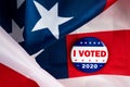 I voted presidential election campaign 2020 vote button; pin laying on the american flag.