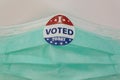 I Voted sticker on protective face mask. Concept of Voting in the USA during coronavirus pandemic Royalty Free Stock Photo