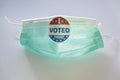 I Voted sticker on protective face mask. Concept of Voting in the USA during coronavirus pandemic Royalty Free Stock Photo