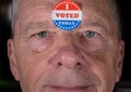 I Voted Today paper sticker on mans forehead with warm smile at camera Royalty Free Stock Photo