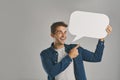 I want everyone to know about this. Studio portrait of a young man pointing to a speech bubble against a grey background