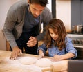 I want mine to be just like yours. a father and daughter working with pizza dough in the kitchen. Royalty Free Stock Photo