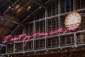 I want my time with you glowing pink words installation by Tracey Emin within interior of St. Pancras, London, UK