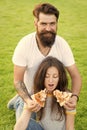 I want them all. summer picnic on green grass. Diet. happy couple eating pizza. Healthy food. fast food. bearded man Royalty Free Stock Photo