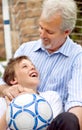 I want to be great at soccer like my dad. Happy father and son playing around with a soccer ball. Royalty Free Stock Photo