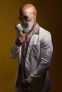 I want to bring back soulful music. Studio shot of a senior man wearing vintage clothes while singing into a microphone.