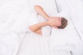 I want to sleep. early morning wakeup. sleep disorders concept. man has sleep problems. man lying white bedroom. time to Royalty Free Stock Photo