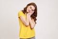 I want to sleep. Portrait of teenager girl with brown curly hair with closed eyes standing with arms