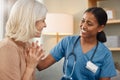 I wanted to give you the good news in person. a doctor having a consultation with a senior woman at home. Royalty Free Stock Photo