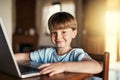 I was born into a technological world. Portrait of an adorable little boy using a laptop at home. Royalty Free Stock Photo