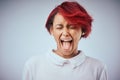 I was not made to be subtle. Studio shot of an attractive young woman screaming against a gray background. Royalty Free Stock Photo