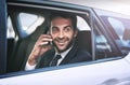 I am on the way. a handsome young businessman making a phonecall while being driven to work. Royalty Free Stock Photo