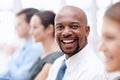 I will achieve - Business motivation. Handsome African American businessman gives you a big smile while attending a Royalty Free Stock Photo