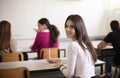 Teenagers students sitting in the classroom and writing. Portrait of student girl Royalty Free Stock Photo
