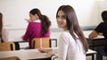 I will be a great student.  Teenagers students sitting in the classroom and writing. Portrait of student girl Royalty Free Stock Photo