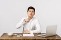 I will kill you. Angry and bothered asian male manager, businessman sitting in office with laptop, documents and coffee Royalty Free Stock Photo