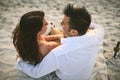 I will always love you. High angle shot of an affectionate young couple sitting face to face on the beach. Royalty Free Stock Photo
