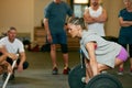 I will not be stopped. a woman lifting weights while a group of people in the background watch on. Royalty Free Stock Photo