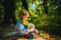 I will show you beauty of nature. Inseparable with toy. Boy cute child play with teddy bear forest background. Child Royalty Free Stock Photo