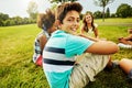 I wish I could chill with my friends every day. Portrait of a young boy sitting together with his friends on the grass