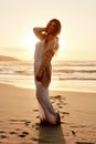 I wish I could press pause on this beautiful day. Portrait of a young woman spending some time at the beach.