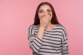 I won`t say anyone. Portrait of scared intimidated woman in striped sweatshirt covering mouth and looking frightened Royalty Free Stock Photo