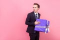 I won`t share! Portrait of resentful greedy man in suit with stylish haircut holding big wrapped present. studio shot isolated, Royalty Free Stock Photo