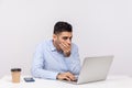 I won`t tell anything! Frightened man employee sitting office workplace, covering mouth looking terrified at laptop screen Royalty Free Stock Photo
